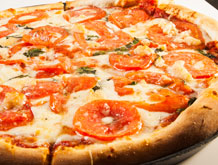 a peperoni pizza with tomatos