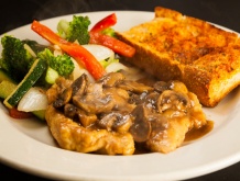 mushroom chicken with garlic bread and veggies